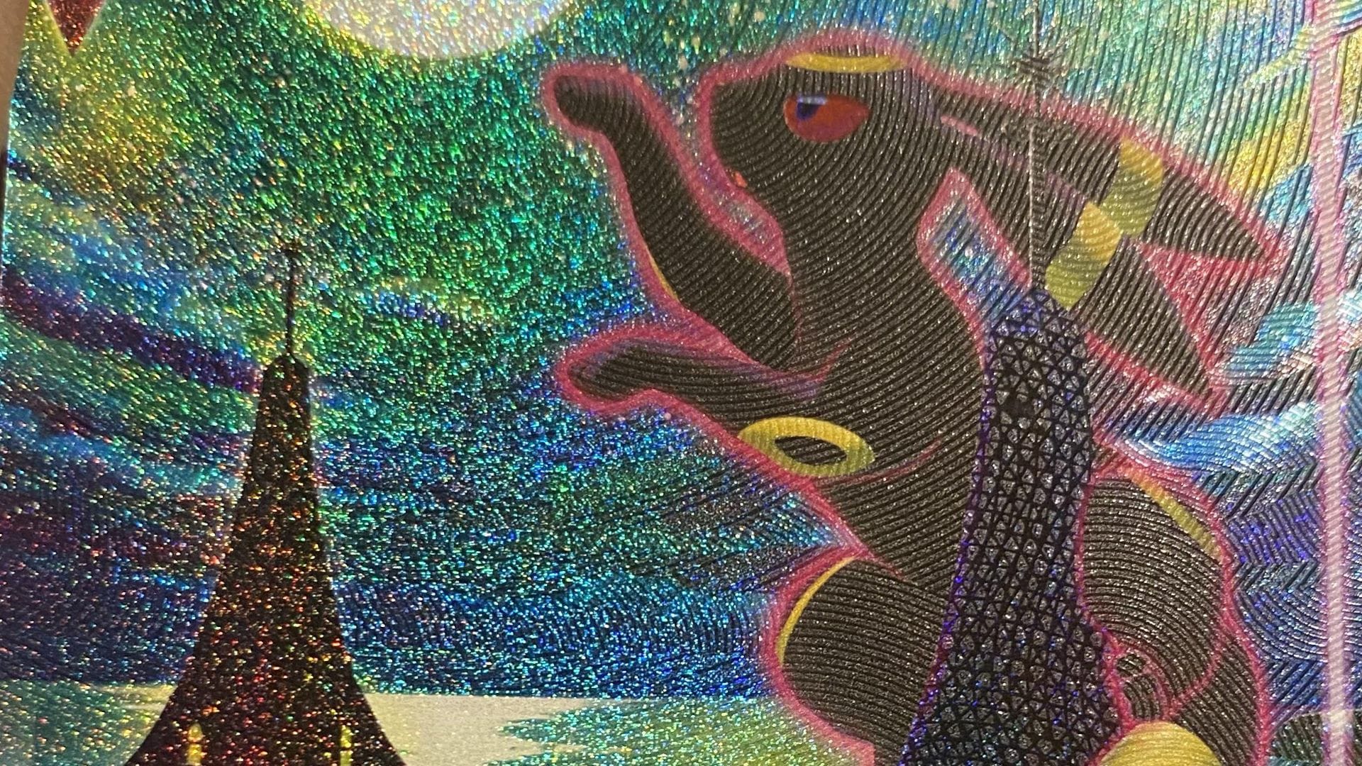 A close up of the artwork and texture of the Moonbreon / Umbreon VMAX Alt Art Pokemon card from Evolving Skies
